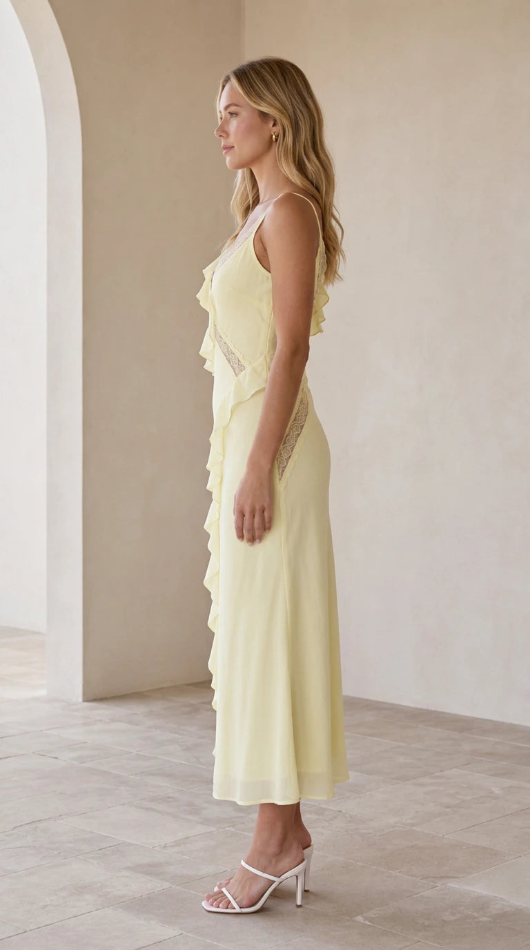 Model wearing yellow slip midi dress, side view