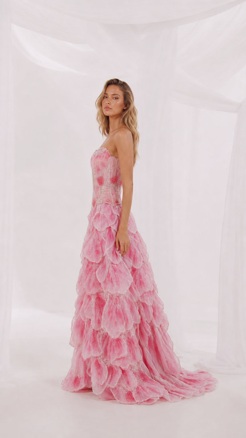 Side profile view of pink strapless evening gown