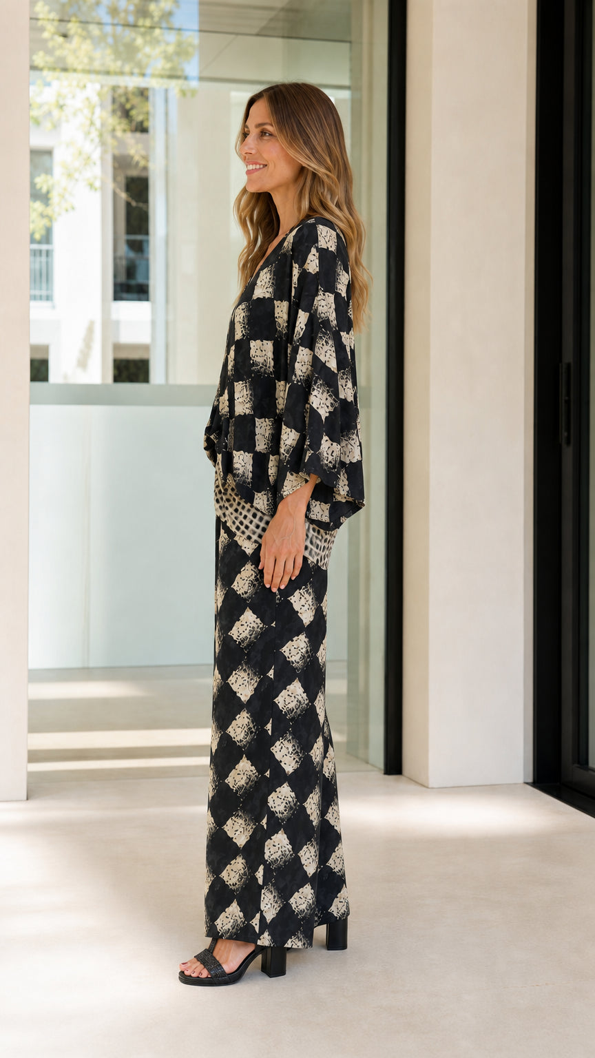Woman wearing black geometric print two-piece set side view