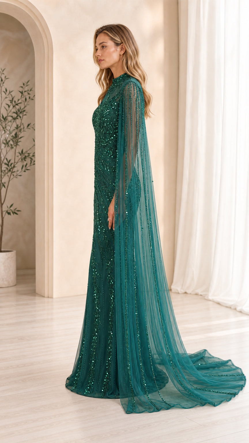 Side view of emerald green sequin gown showing fit and train