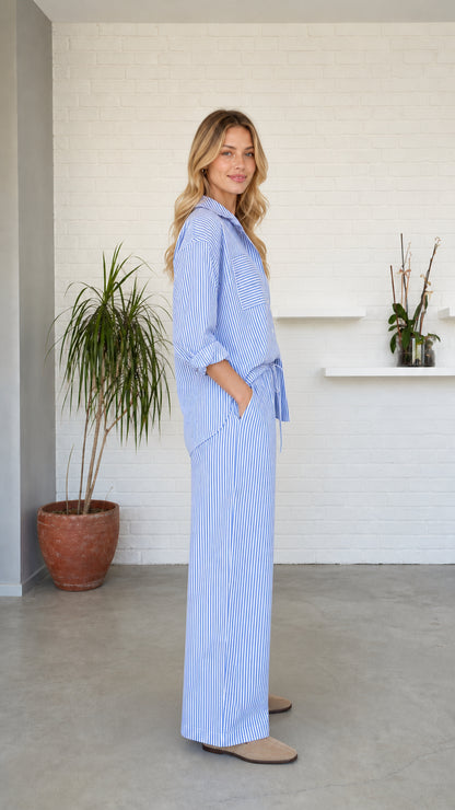 Side profile of woman wearing blue striped two-piece lounge set