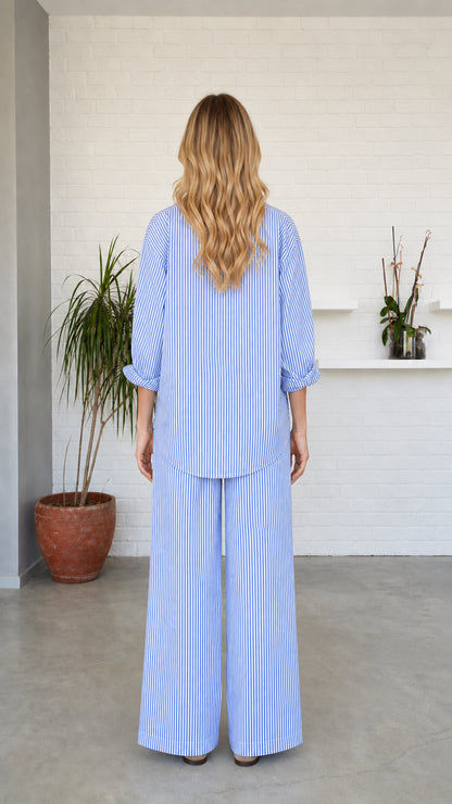 Back view of woman wearing blue striped lounge set