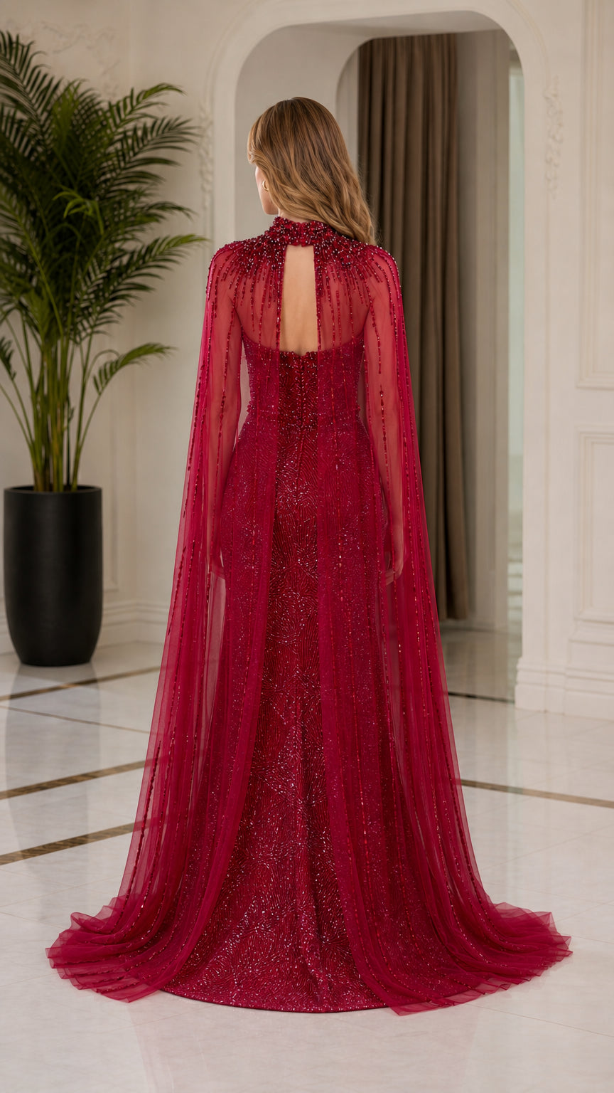 Back view of burgundy formal gown with sheer cape overlay and back cutout detail