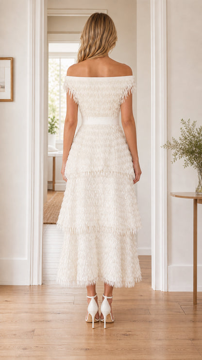 Back view of woman wearing white fringe dress