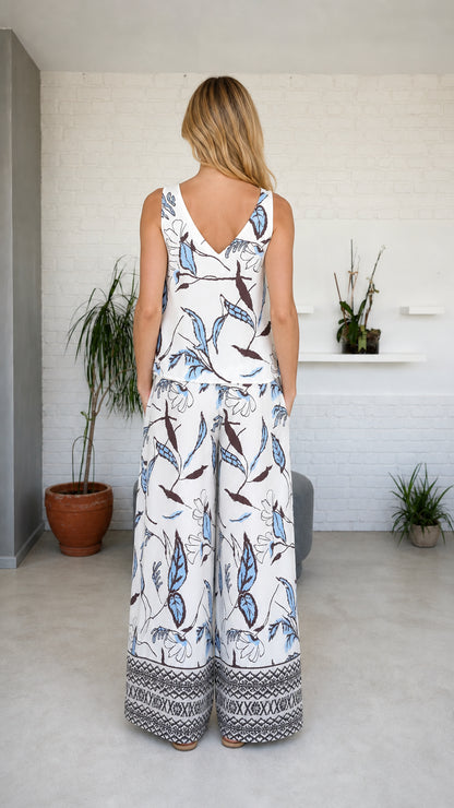 Model wearing white botanical print set, back view