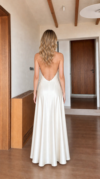 Back view showcasing open back design of ivory satin maxi dress