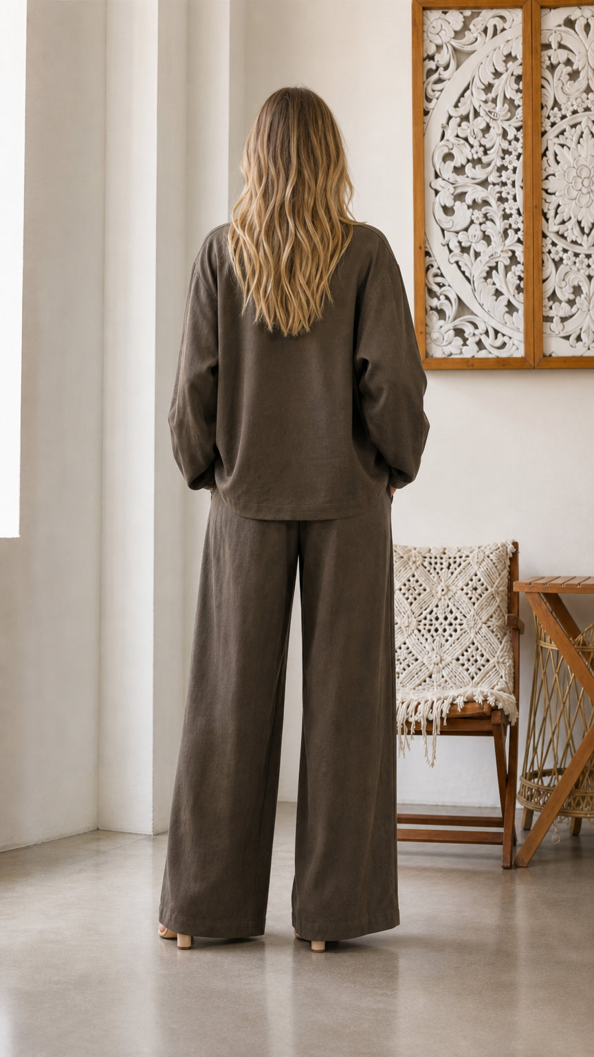 Back view of model in olive pants and blazer set