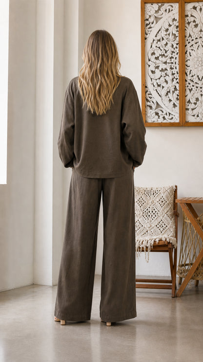 Back view of model in olive pants and blazer set
