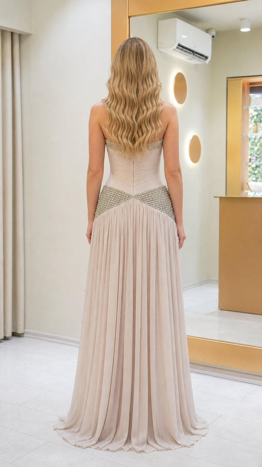 Back view of beige formal dress with pleated skirt