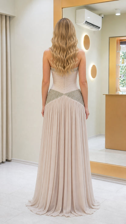 Back view of beige formal dress with pleated skirt