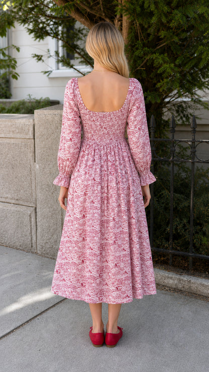 Model wearing red vintage toile print midi dress back view
