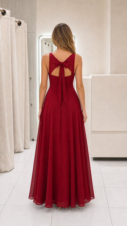 Model wearing burgundy chiffon maxi dress back view showing bow