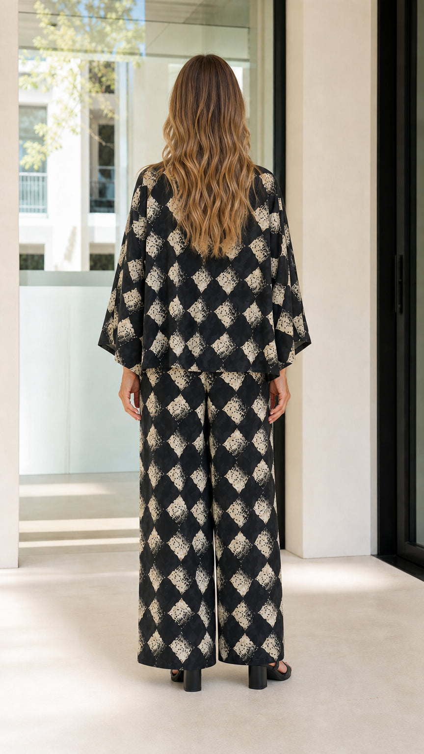 Woman wearing black geometric print two-piece set back view