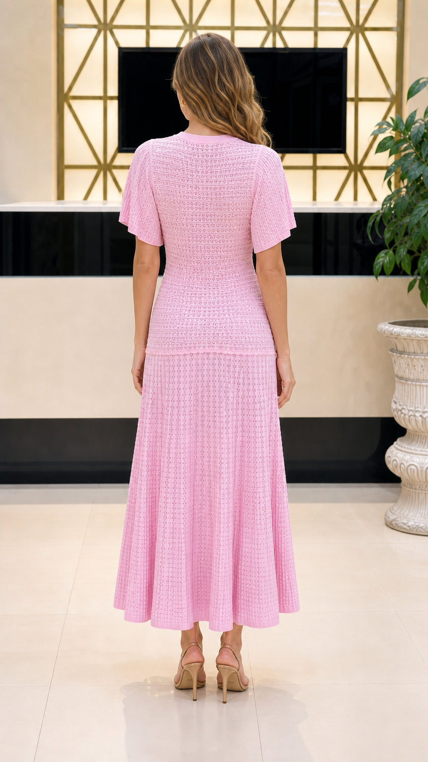 Back view of model wearing pink knit midi dress