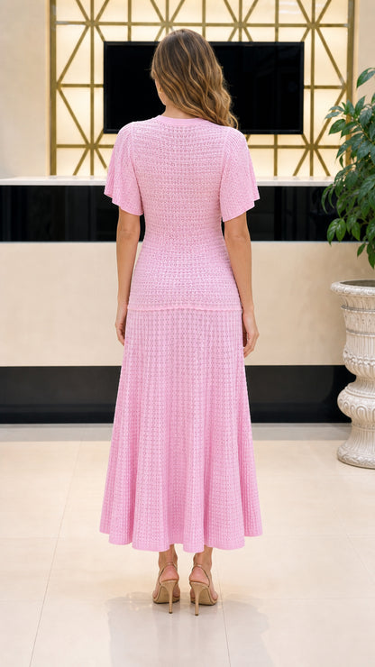 Back view of model wearing pink knit midi dress