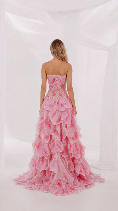 Back view of pink strapless evening gown with sweep train