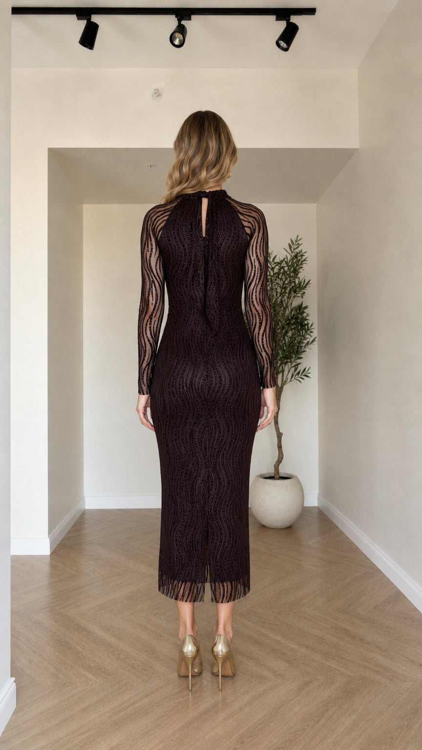 Back view of model showing the keyhole and zipper closure on the Dark Plum midi dress