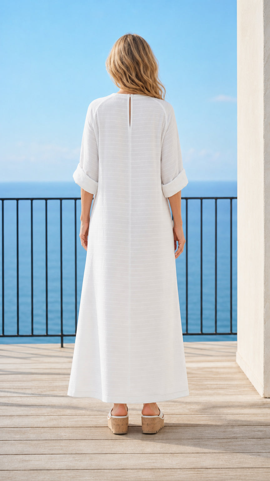 Woman wearing white maxi dress back view