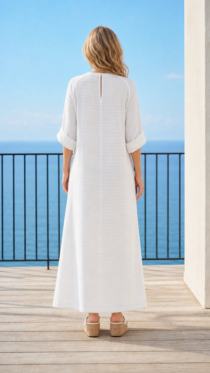 Woman wearing white maxi dress back view