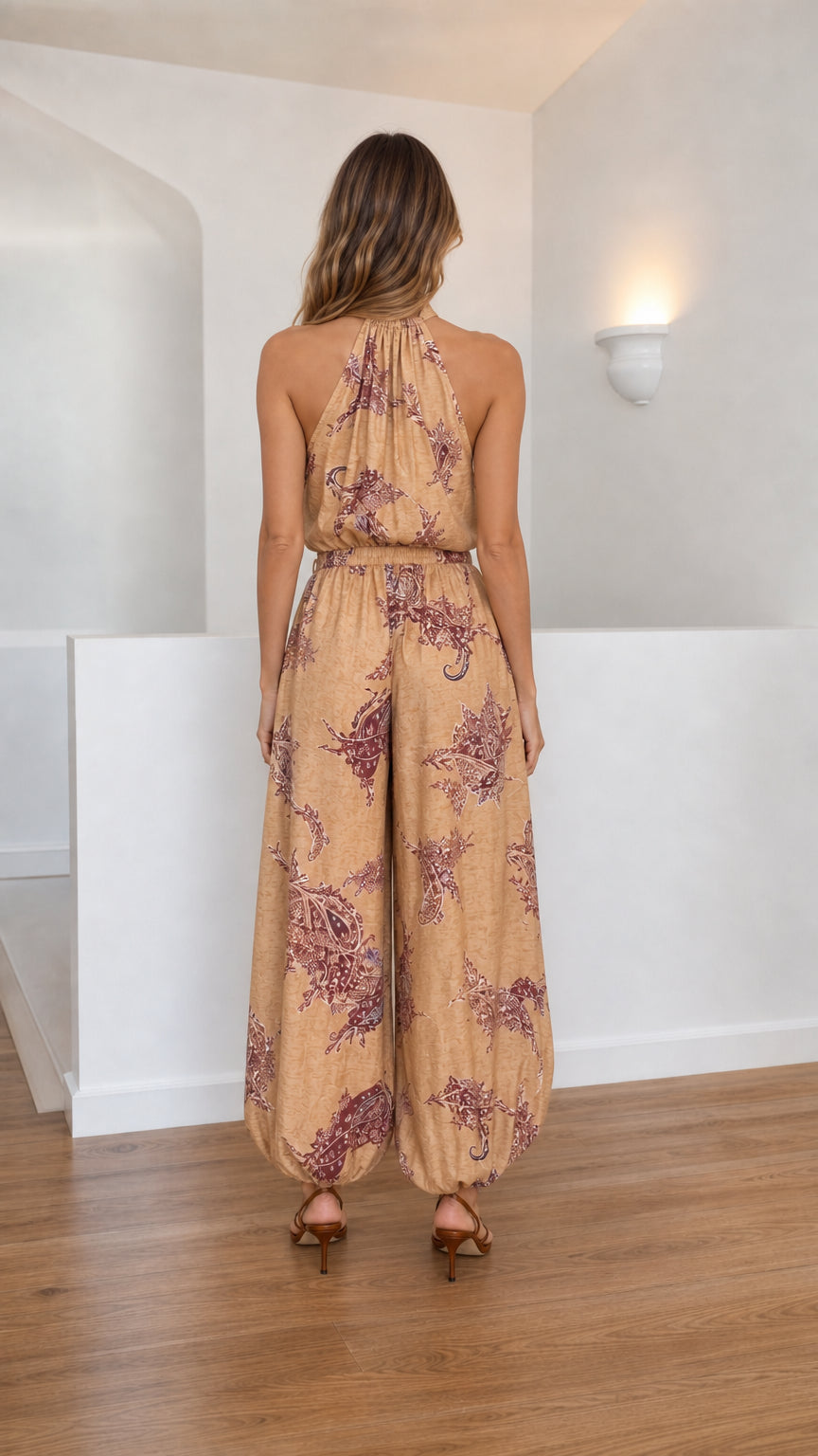 Back view of khaki paisley jumpsuit with halter straps