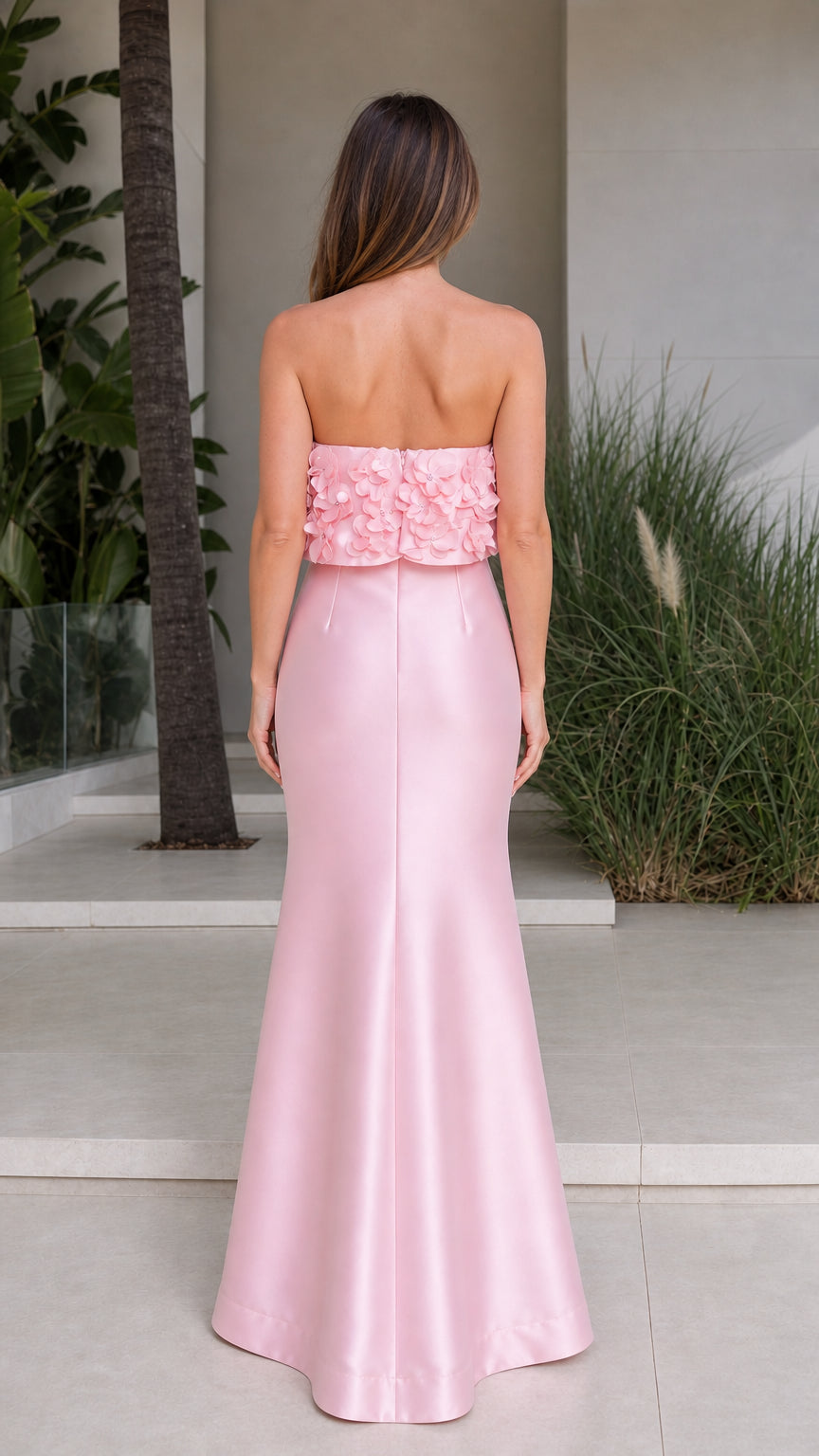 Back view of pink strapless maxi dress with floral overlay