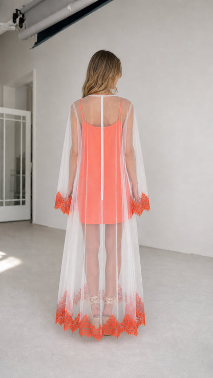 Model wearing coral two-piece set, back view highlighting floor-length hem