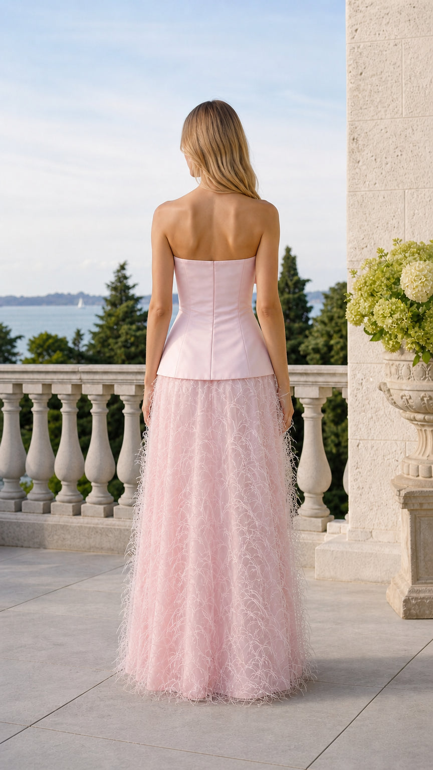 Back view of pink strapless top and feather skirt set