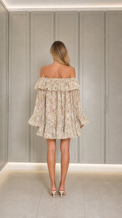 Back view of model wearing beige off-shoulder dress