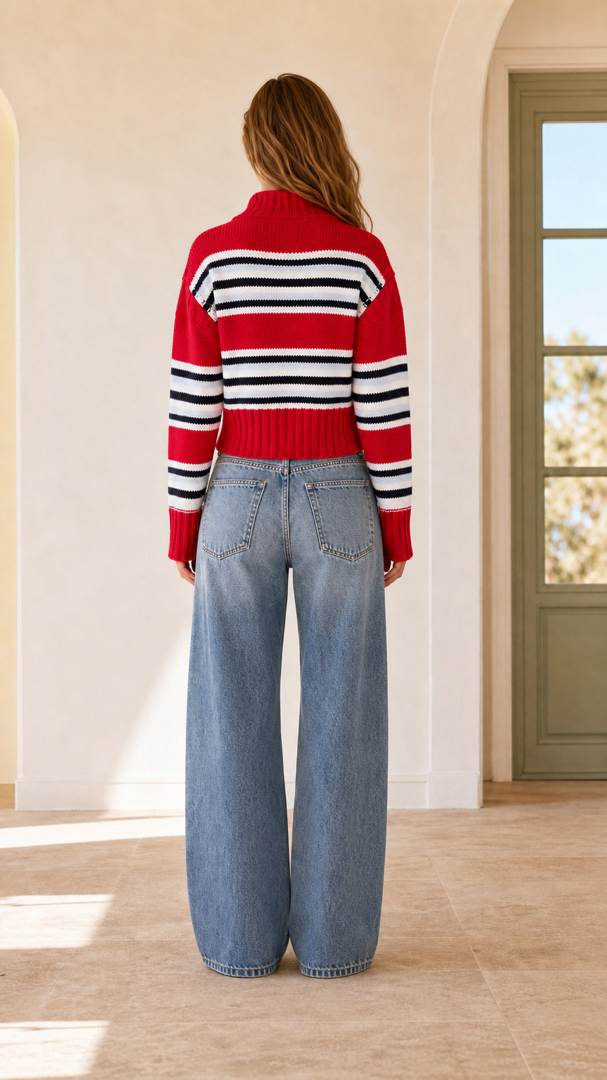 Back view of woman wearing red and navy striped quarter-zip sweater