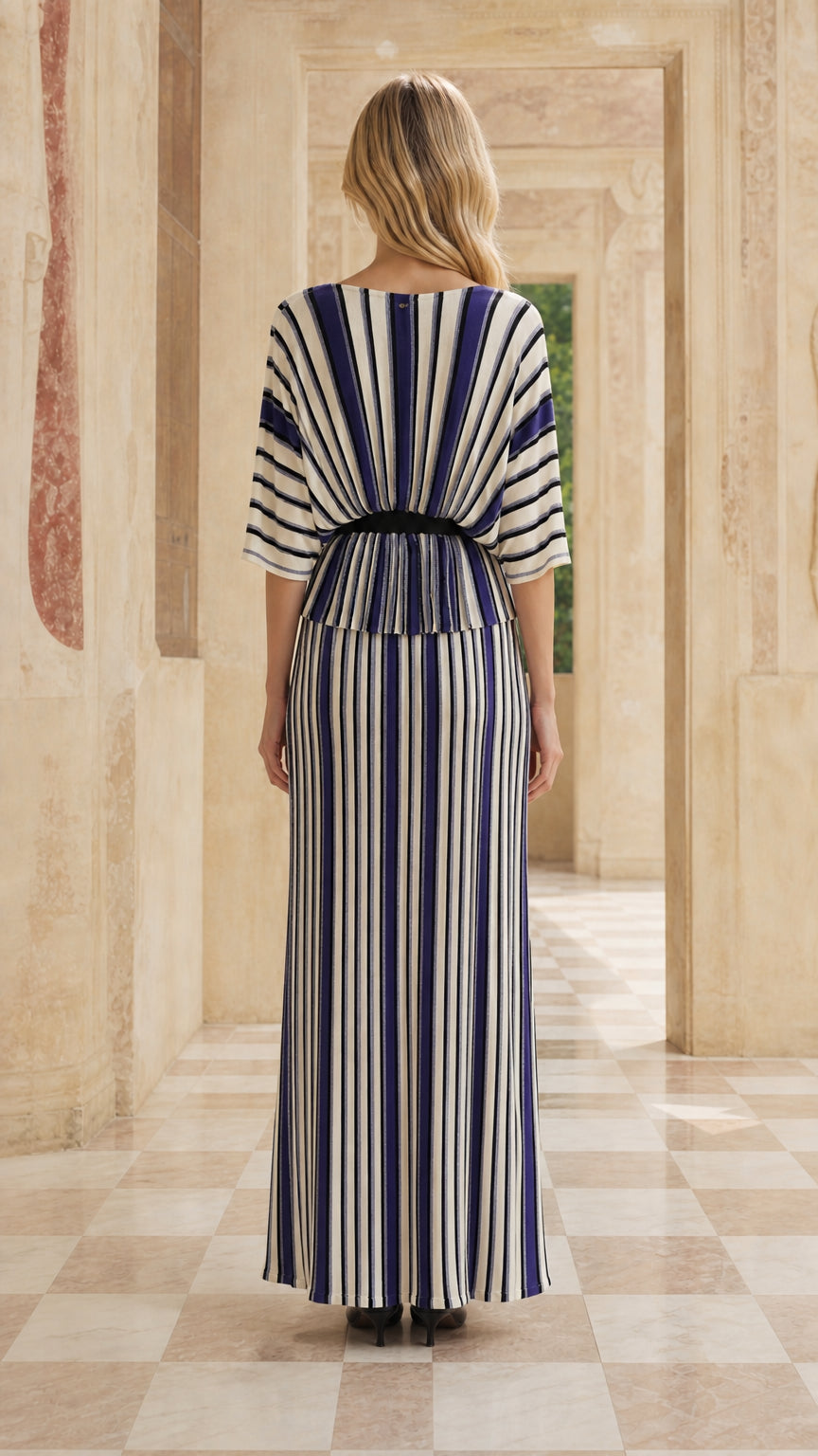 Back view of woman in blue striped maxi set