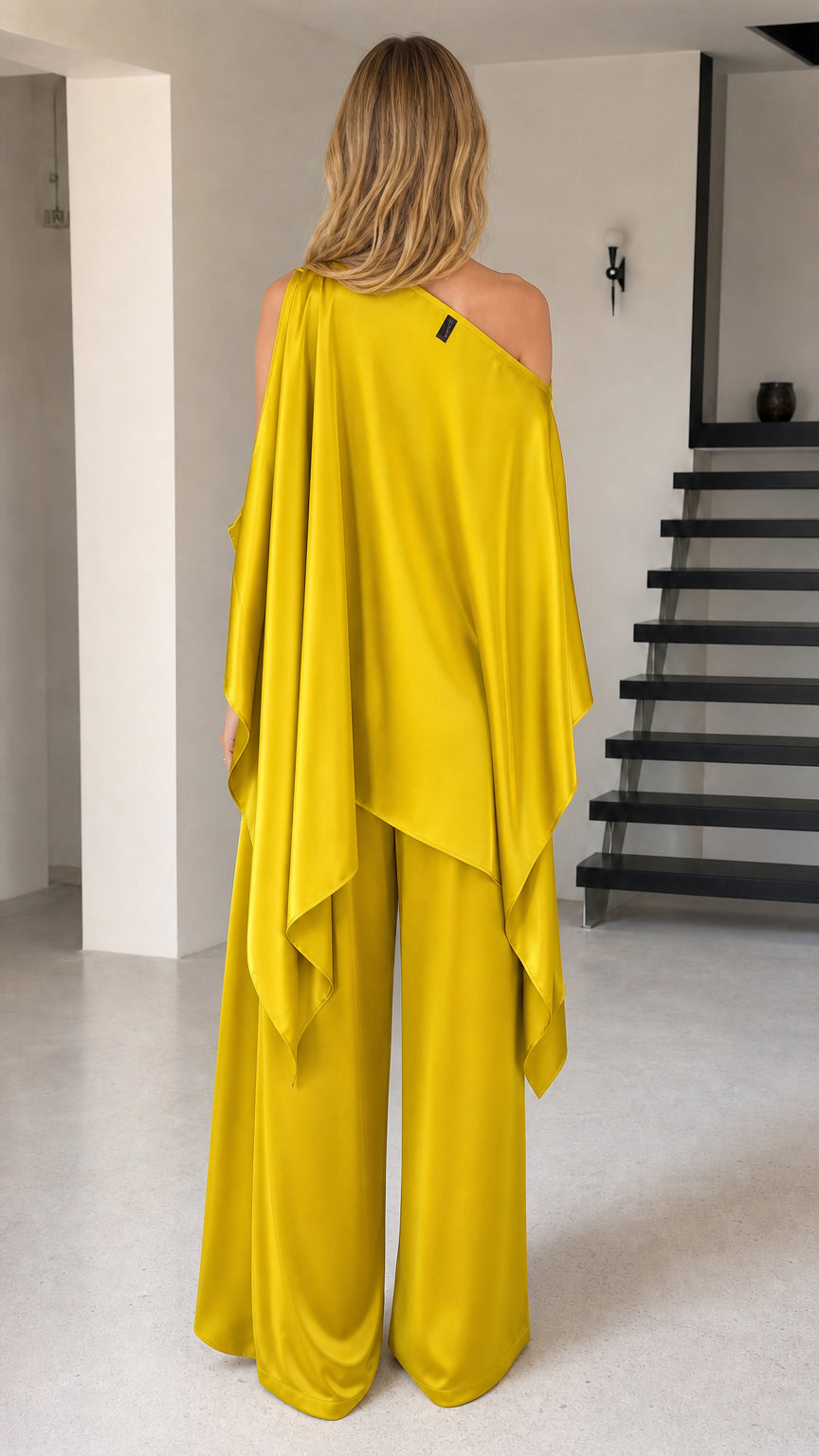 Back view of yellow flowy cape top and wide-leg trousers