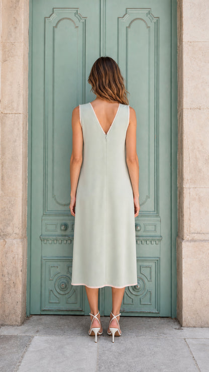 Model wearing sage green embellished midi dress, back view