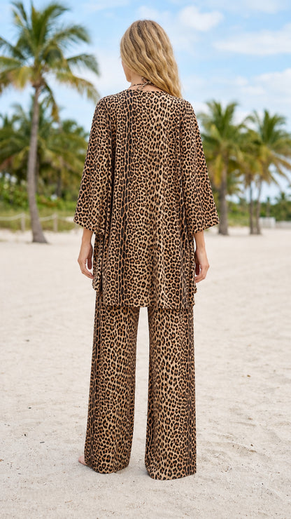 Back view of model wearing brown leopard print cardigan and trousers