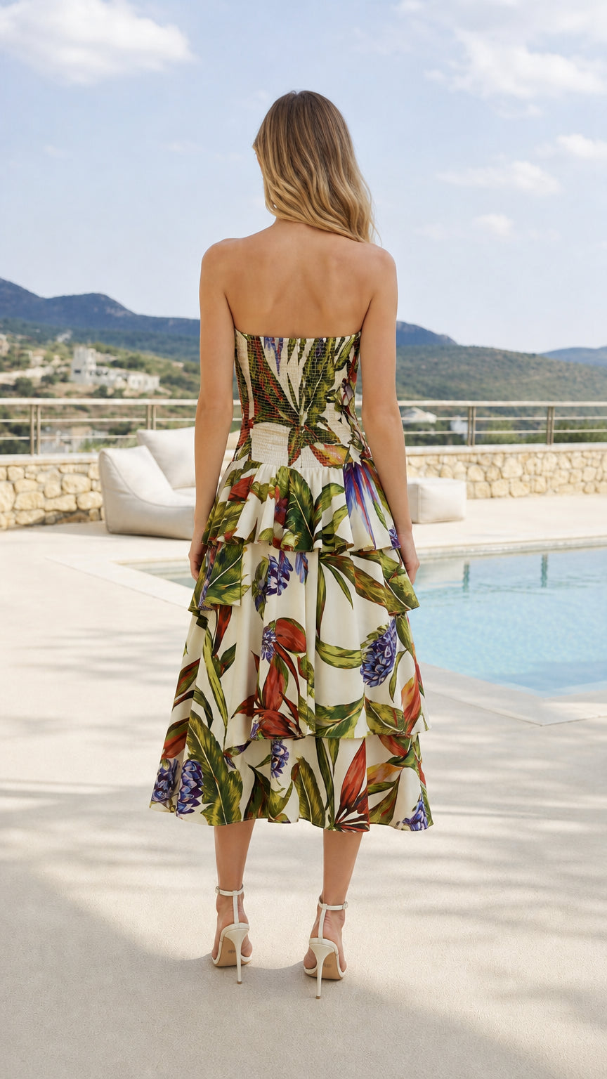 Back view of model showcasing smocked bodice on tropical print dress