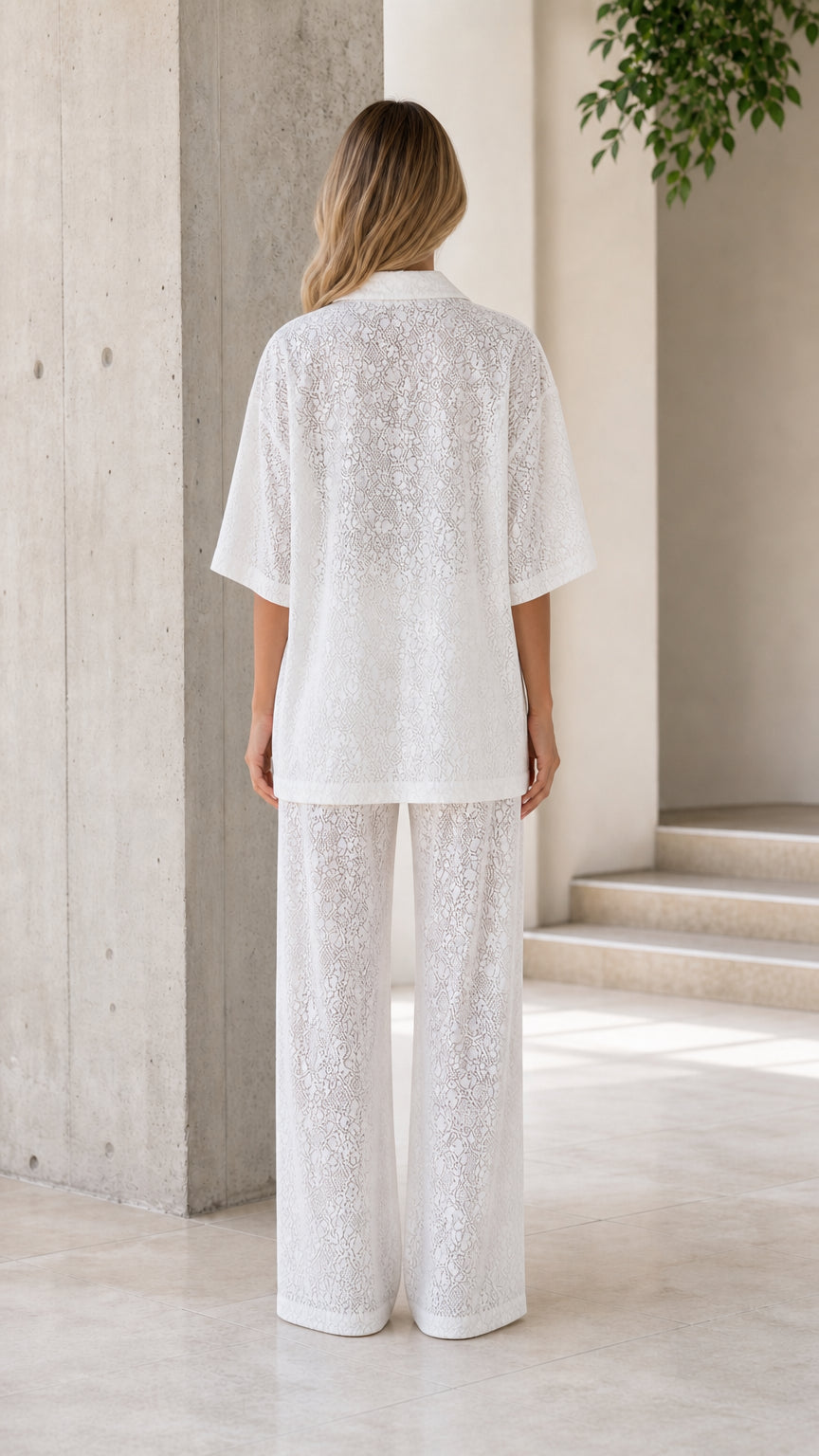 Back view of woman wearing white lace two-piece lounge set