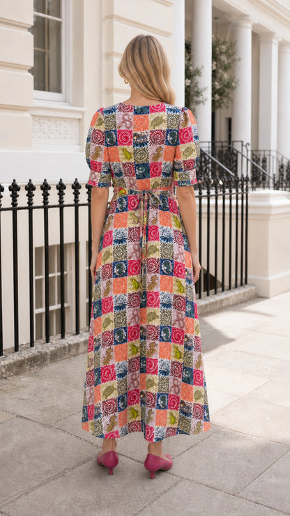 Back view of woman wearing multi-color patchwork midi dress