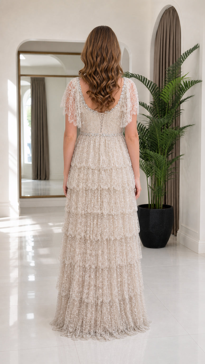 Back view of model wearing champagne tiered evening maxi dress