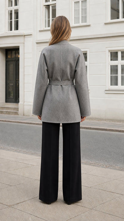 Back view of the heather gray thigh-length coat with a clean seam and tied belt