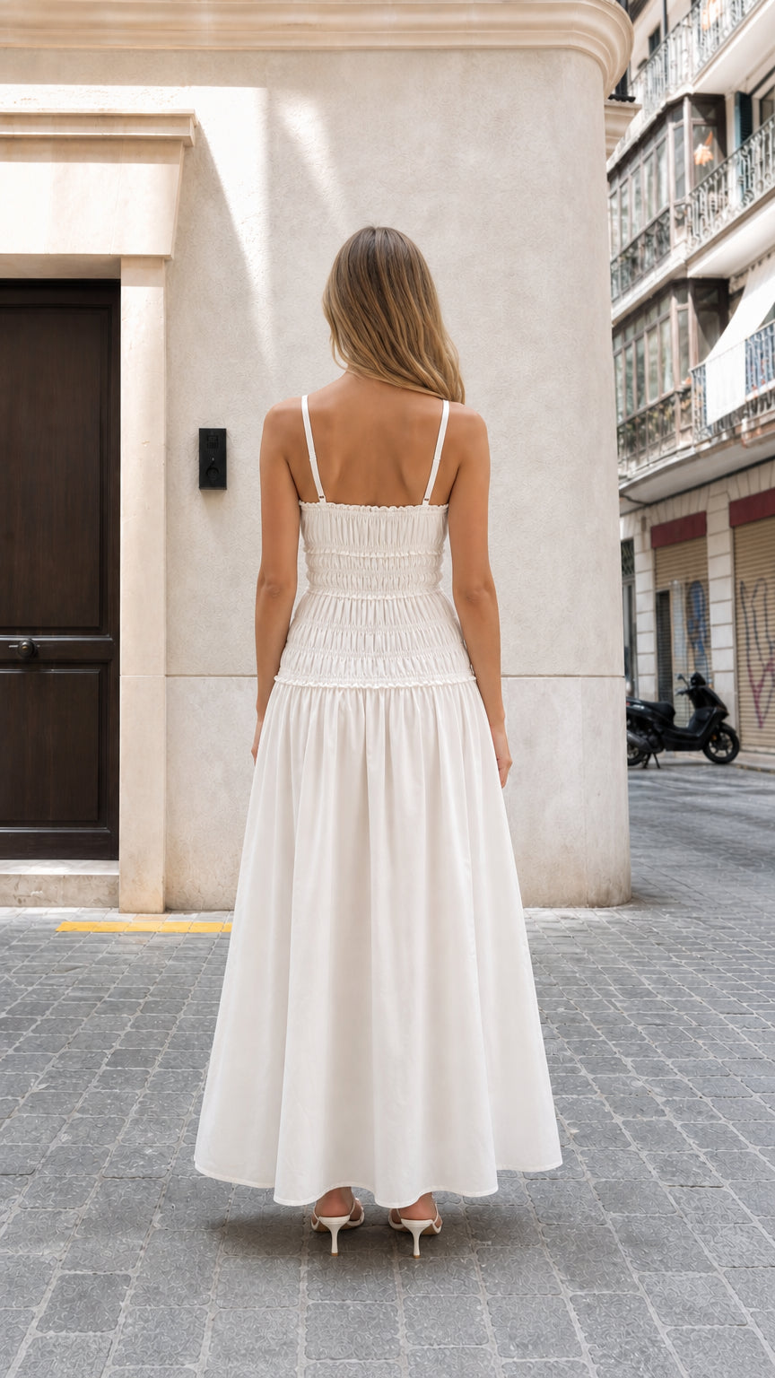 Model wearing white smocked maxi dress back view