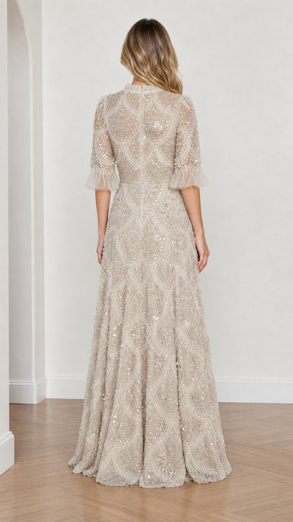 Model wearing Champagne embellished ruffle mock neck maxi dress, back view