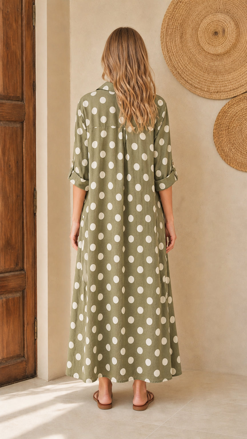 Back view of woman wearing olive polka dot maxi shirt dress