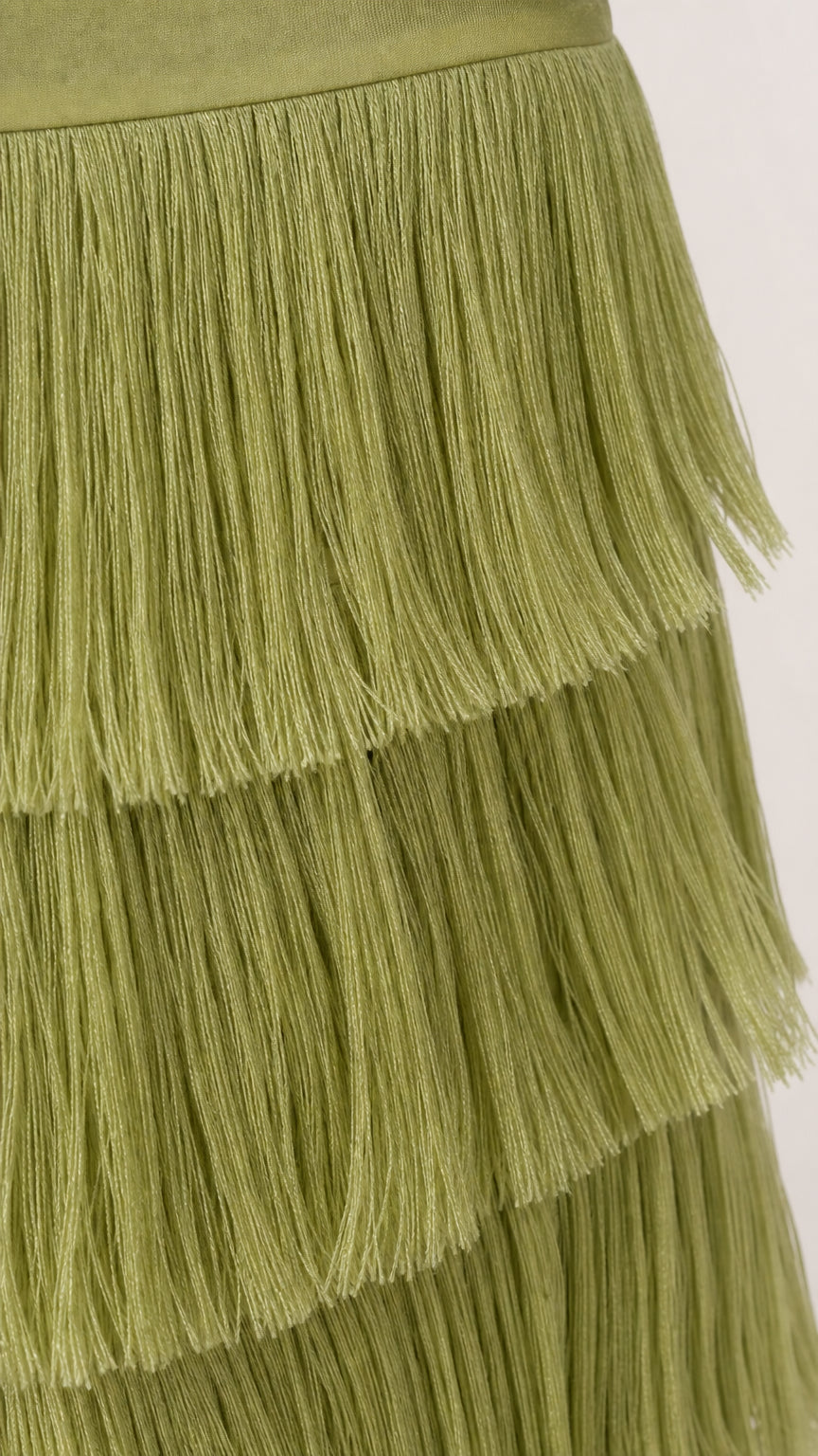 Close-up detail of textured green fringe tiers