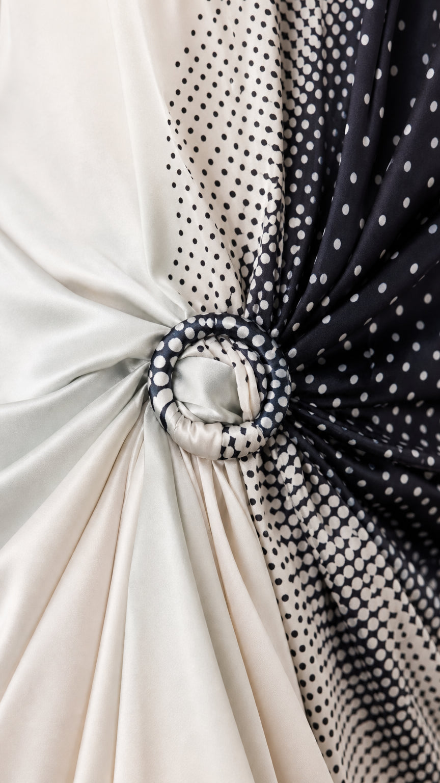 Close-up of fabric texture, polka dot pattern, and O-ring knot detail