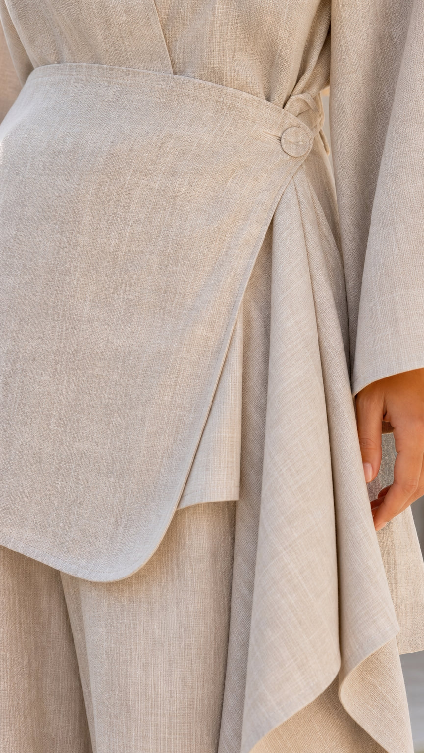 Close-up detail of side button wrap closure on tunic