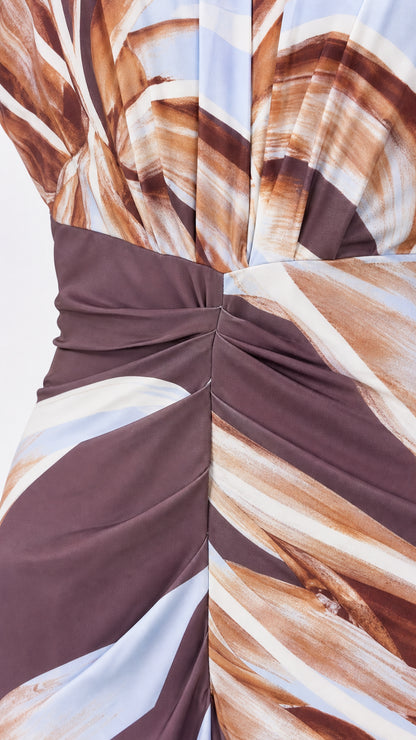 Close-up detail of the waist ruching and abstract fabric pattern