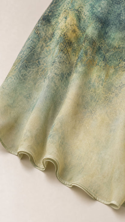 Close up of textured fabric and hemline on Green ombre dress
