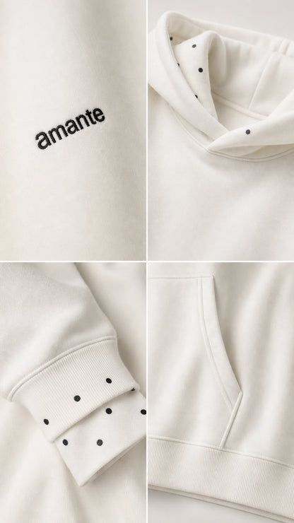 Close-up details of white hoodie embroidery, pocket, and cuff