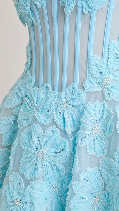 Close-up detail of sheer boned bodice and embroidered floral appliques