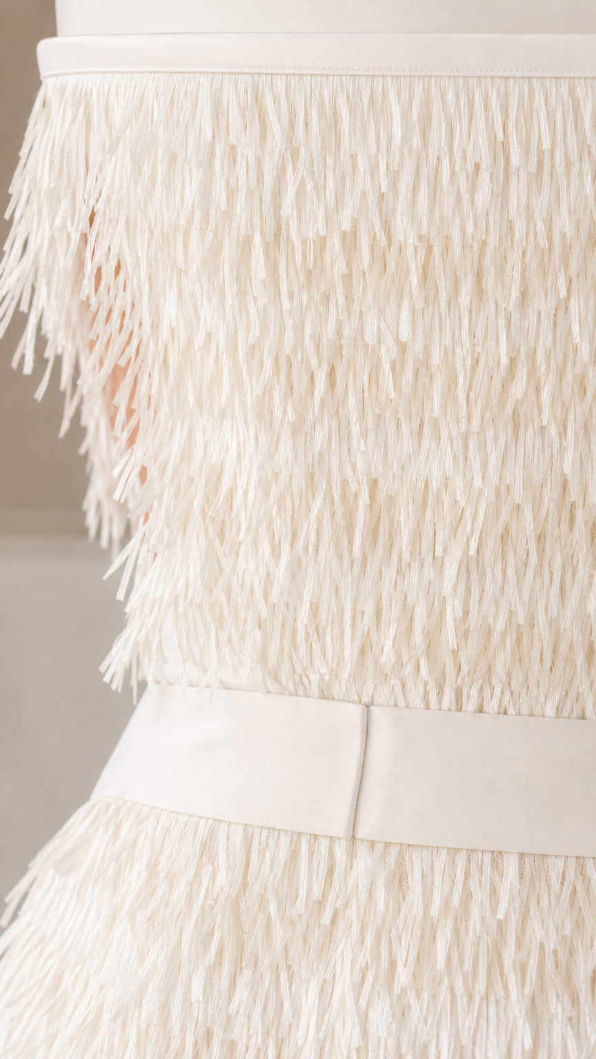 Close up of textured fringe detail and waistband