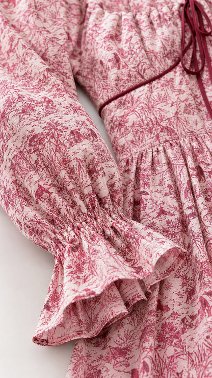 Close-up of sleeve and bow detail on red midi dress